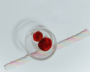 Close-up of strawberries on glass against white background