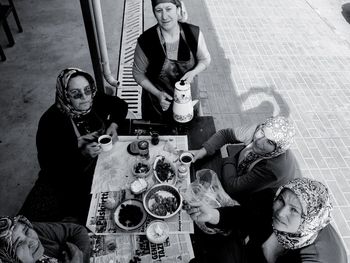 Portrait of women having meal at sidewalk cafe