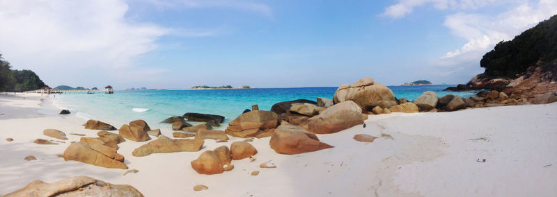 Rocks on beach against sky