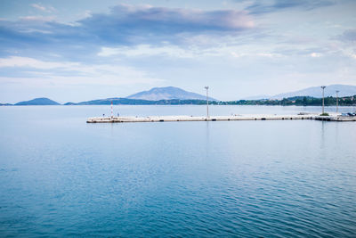 Sailboats in sea against sky