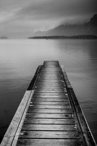 Pier over lake against sky