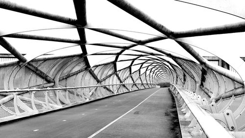 Footbridge over road against sky