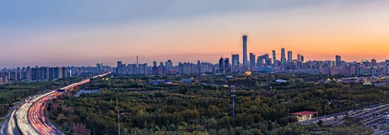 Panoramic view of cityscape against sky during sunset