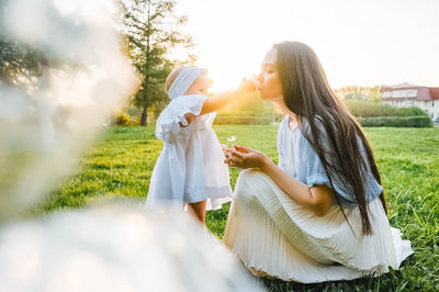 Rear view of woman with arms raised