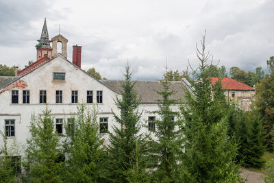 Trees and buildings against sky