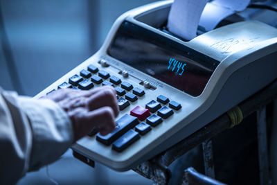 Close up of a person using a calculator