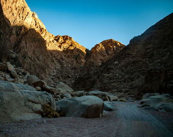 Rocks in mountains against clear blue sky