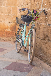 Bicycle parked against wall