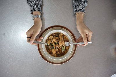 Directly above shot of woman holding ice cream in bowl