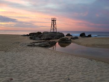 Scenic view of beach against sky during sunset