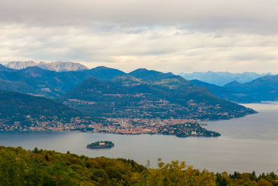 Scenic view of sea and mountains against sky