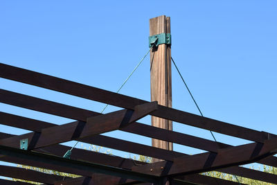 Low angle view of bridge against clear blue sky