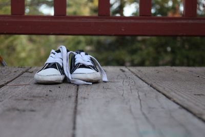 Close-up of shoes on footbridge