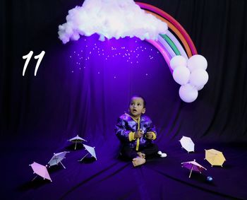 Rear view of baby boy with clouds,rain, rainbow 