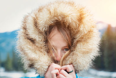 Close-up portrait of woman with snow