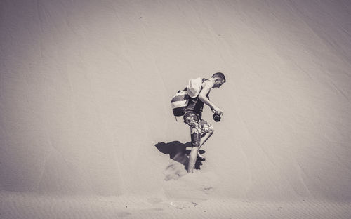 Man with bicycle on wall