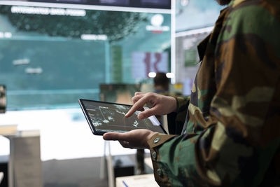 Midsection of man using laptop at office