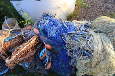 Close-up of cropped hand holding fishing net