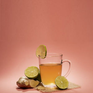 Cup of tea with lemon, ginger and honey in a table