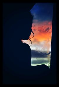 Silhouette of woman against sky