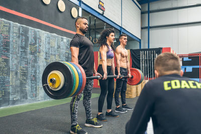 Rear view of man exercising in gym