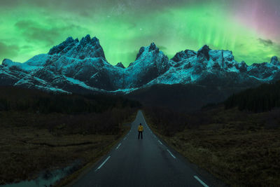 Road amidst snowcapped mountains against sky