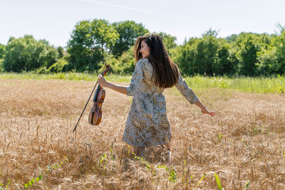 Full length of woman standing on field