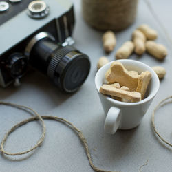 Cookies by camera in cup on table