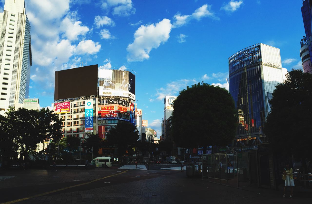 building exterior, architecture, built structure, city, modern, sky, tree, office building, skyscraper, tower, tall - high, building, low angle view, street, city life, cloud - sky, glass - material, cloud, day, outdoors