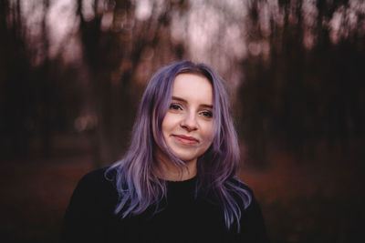 Portrait of cute happy hipster young woman in park during autumn