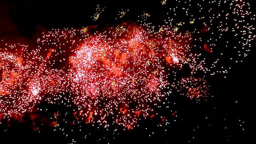 Low angle view of firework display at night