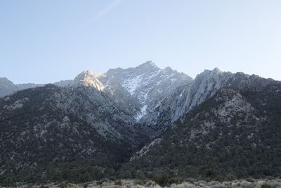 Scenic view of snowcapped mountains against clear sky
