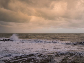 Scenic view of sea against dramatic sky