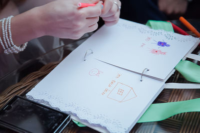 Close-up of hands and notebook 