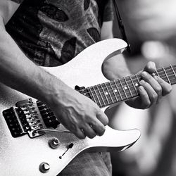 Cropped image of man playing guitar