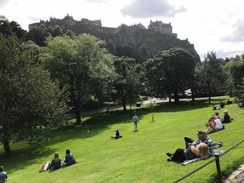 People sitting in park against sky