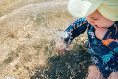 High angle view of boy holding water