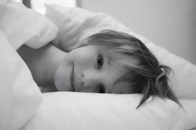 Portrait of boy relaxing on bed at home