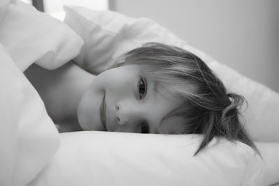 Portrait of woman relaxing on bed at home