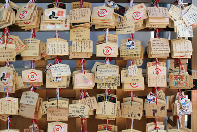 Full frame shot of text hanging outside temple