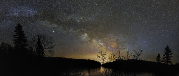 Scenic view of lake against sky at night