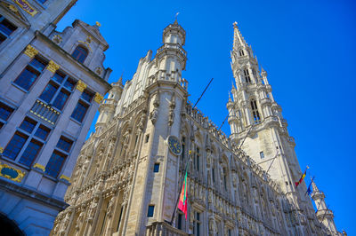 Low angle view of buildings against blue sky