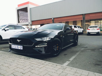 Cars parked on road by buildings in city