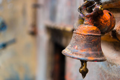 Close-up of rusty metal hanging against wall