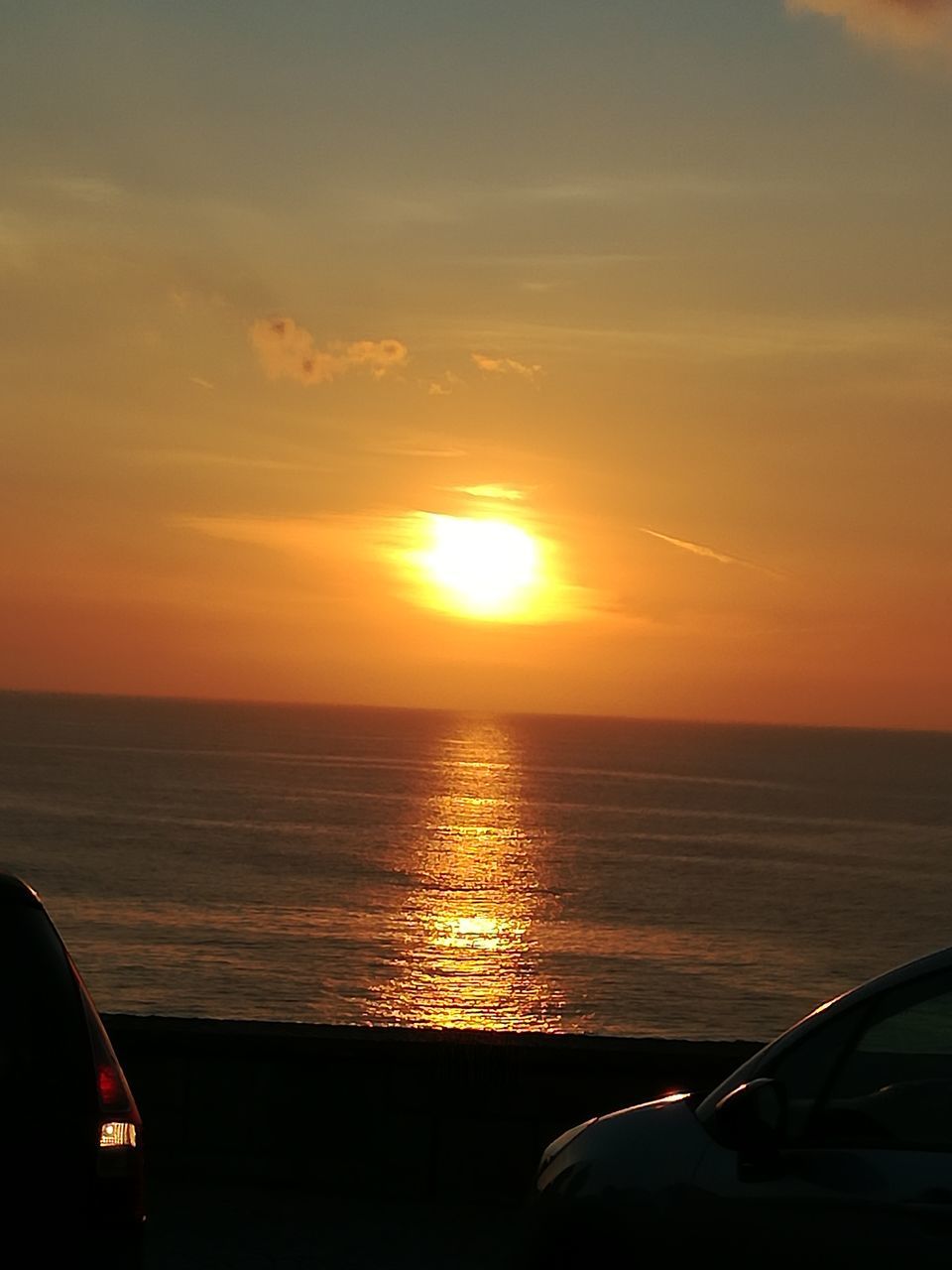 sunset, sea, car, orange color, beauty in nature, transportation, sky, horizon over water, nature, sun, scenics, land vehicle, mode of transport, no people, beach, tranquility, water, outdoors, day