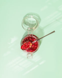 Fermentation natural berries. glass jar with fermented honey cranberries on mint background