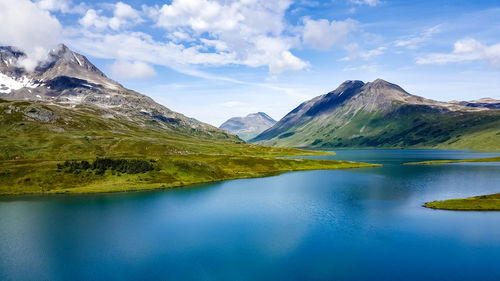 Scenic view of lake and mountains against sky