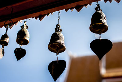 Low angle view of lanterns hanging by building