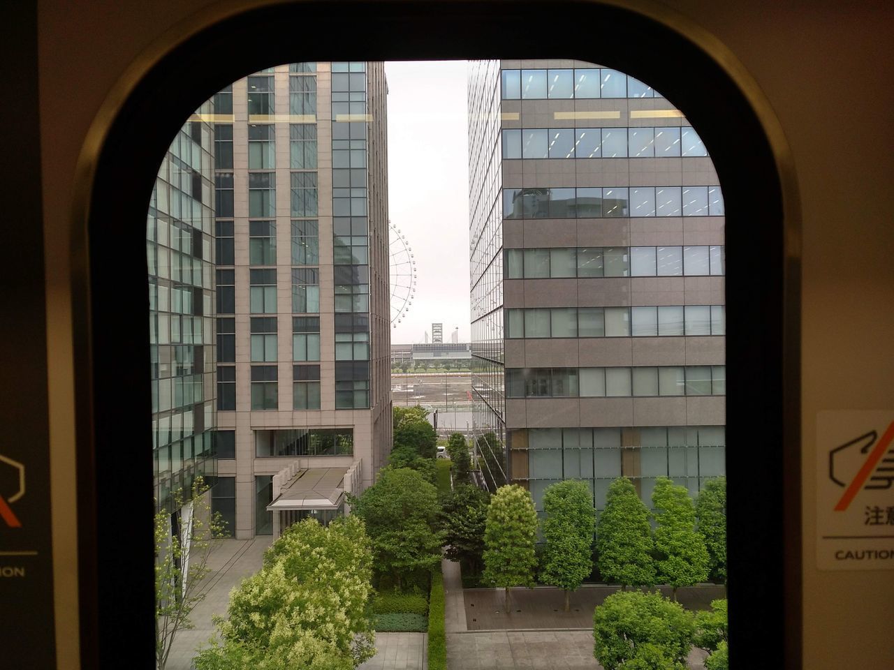 VIEW OF BUILDINGS AGAINST CLEAR SKY SEEN THROUGH GLASS WINDOW