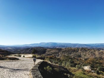 Panoramic view of landscape against clear blue sky